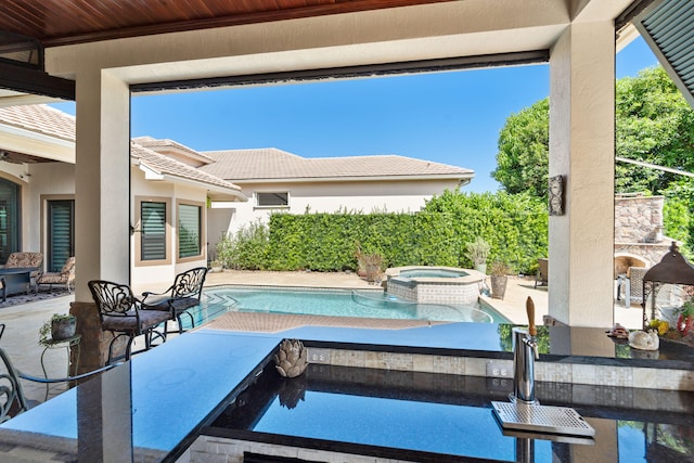 view of pool featuring an in ground hot tub and a patio area