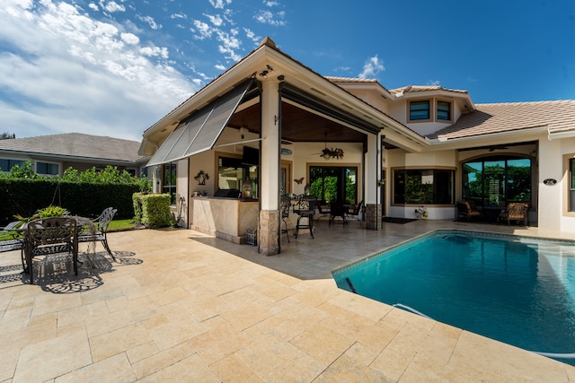 view of swimming pool featuring a patio area and ceiling fan