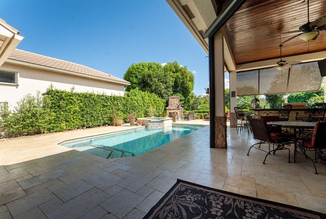 view of swimming pool with a patio area and ceiling fan