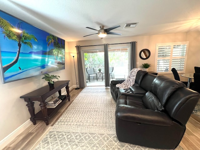 living room with hardwood / wood-style flooring and ceiling fan