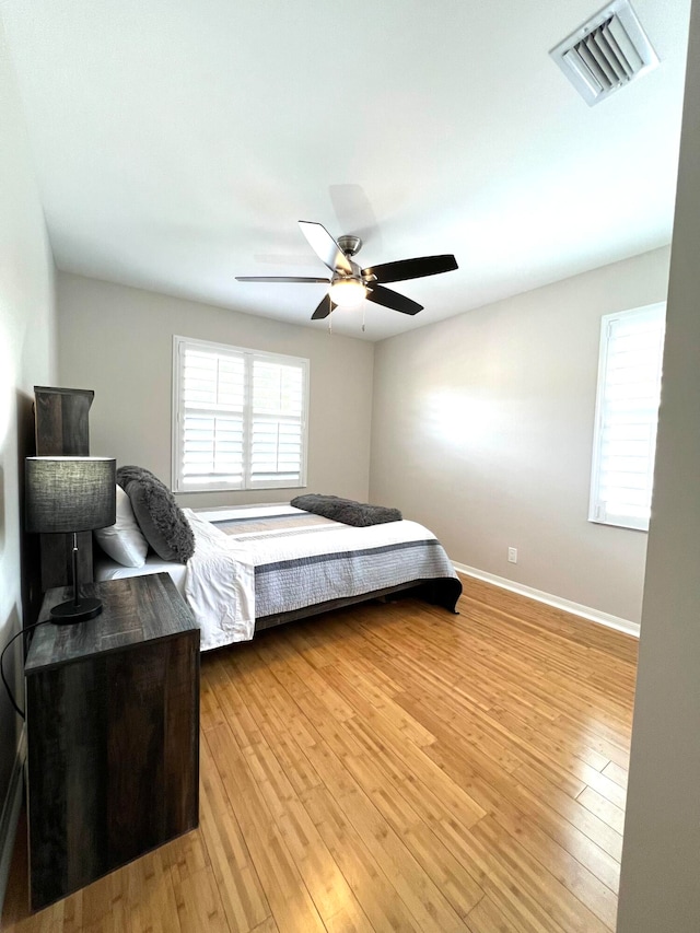 bedroom featuring light hardwood / wood-style floors and ceiling fan