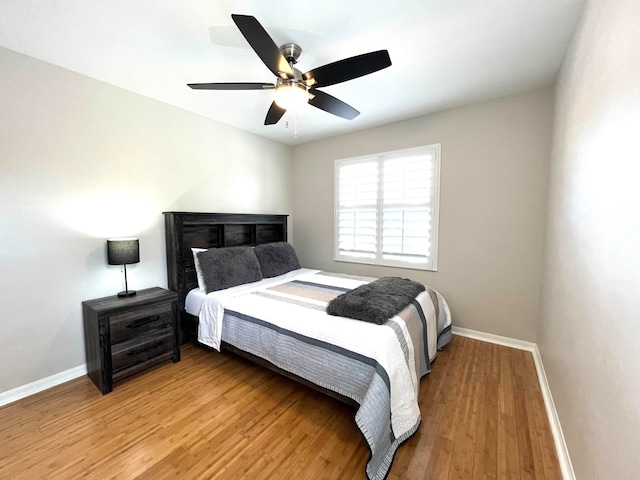 bedroom with light hardwood / wood-style flooring and ceiling fan