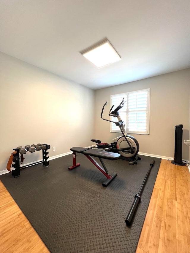 workout area with hardwood / wood-style floors