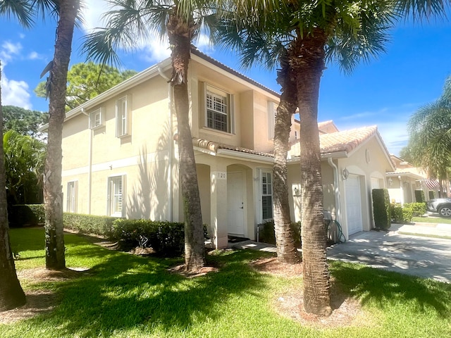 view of front facade with a front yard and a garage