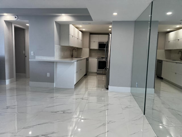 kitchen with stainless steel appliances, backsplash, and sink