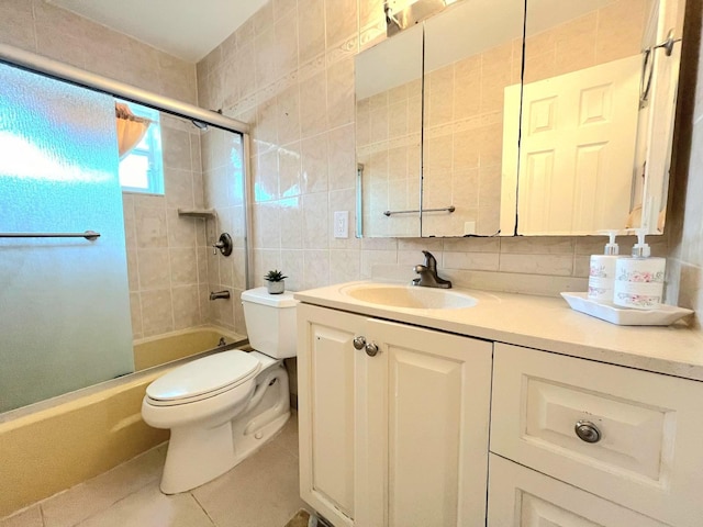 full bathroom featuring shower / bath combination with glass door, vanity, tile walls, toilet, and decorative backsplash