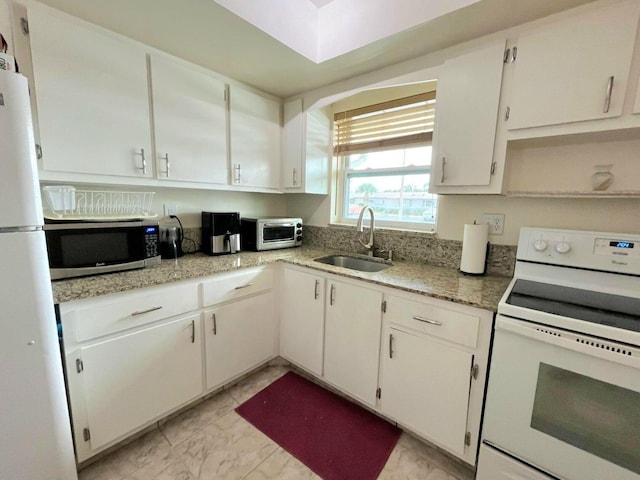 kitchen featuring white cabinets, white appliances, ventilation hood, and sink