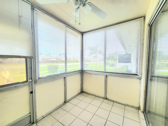 unfurnished sunroom featuring ceiling fan