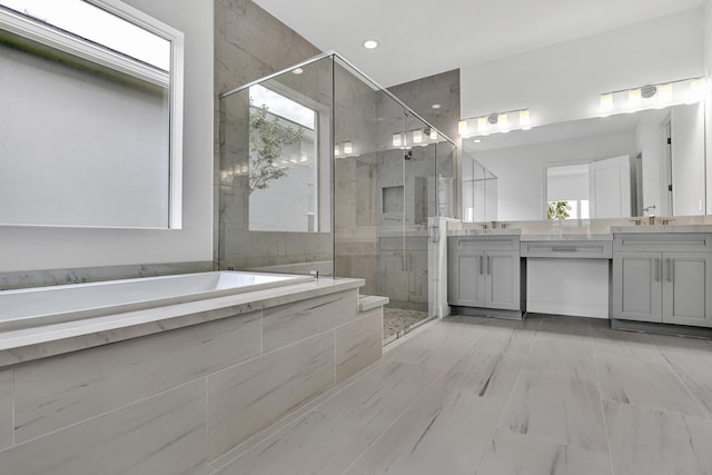 10125 Driftwood Way, Palm Beach Gardens, FL 33412 - bathroom featuring vanity, a garden tub, and a shower stall