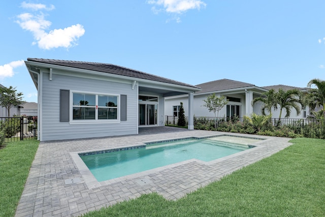 10125 Driftwood Way, Palm Beach Gardens, FL 33412 - rear view of property with a patio