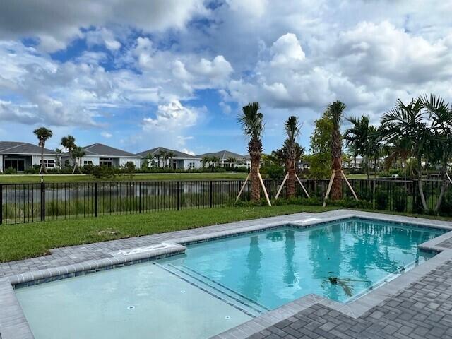 10125 Driftwood Way, Palm Beach Gardens, FL 33412 - view of pool with a fenced backyard, a water view, and a residential view