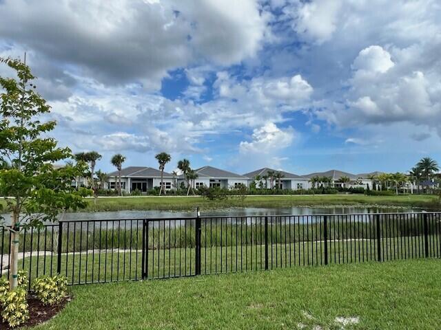 10125 Driftwood Way, Palm Beach Gardens, FL 33412 - view of yard with a residential view and a water view