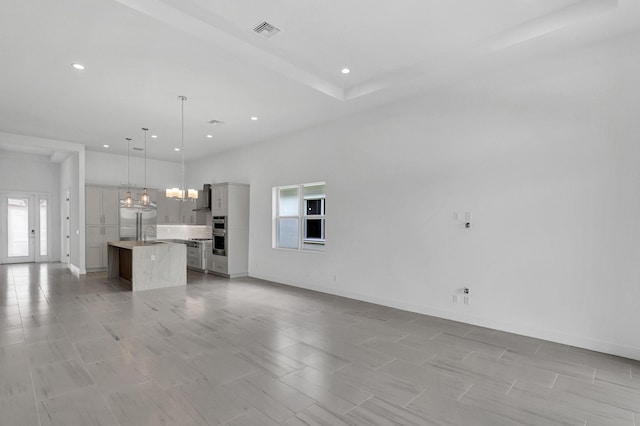 10125 Driftwood Way, Palm Beach Gardens, FL 33412 - unfurnished living room with a chandelier and recessed lighting
