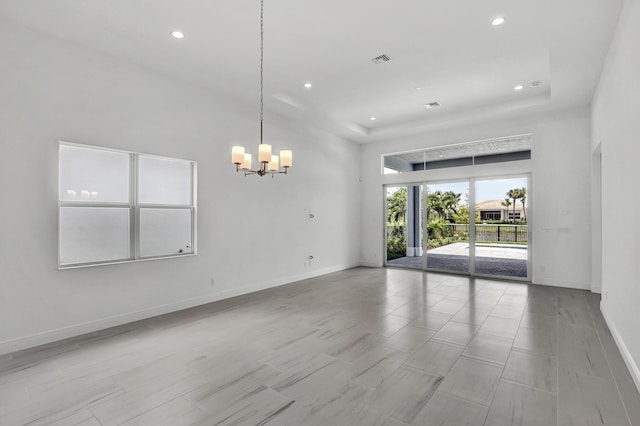 10125 Driftwood Way, Palm Beach Gardens, FL 33412 - spare room with a chandelier, recessed lighting, and a raised ceiling