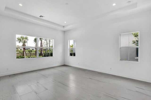 10125 Driftwood Way, Palm Beach Gardens, FL 33412 - empty room featuring a raised ceiling and recessed lighting