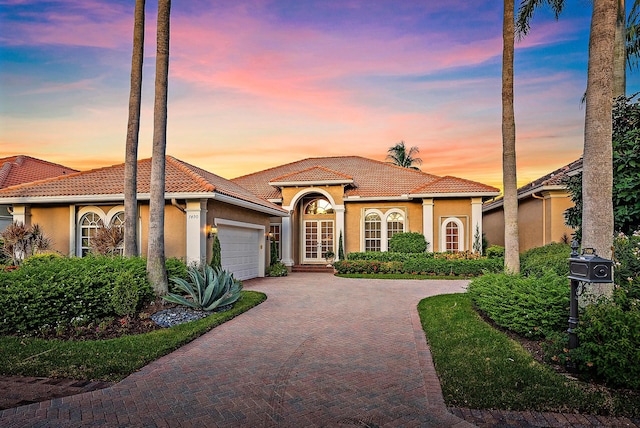 mediterranean / spanish house featuring a garage