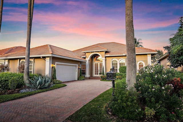 mediterranean / spanish-style home with a garage