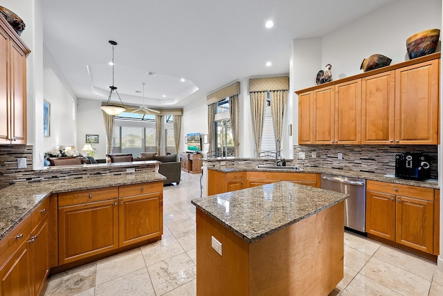 kitchen with kitchen peninsula, tasteful backsplash, stainless steel dishwasher, decorative light fixtures, and a center island