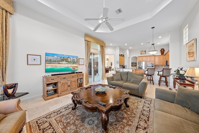 living room featuring a healthy amount of sunlight and ceiling fan