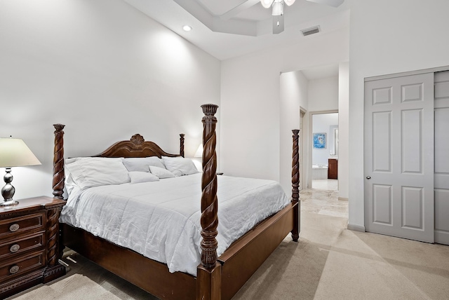 carpeted bedroom featuring ceiling fan, a closet, and a high ceiling