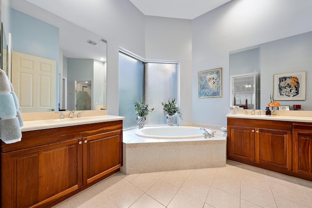 bathroom featuring tile patterned flooring, independent shower and bath, and vanity