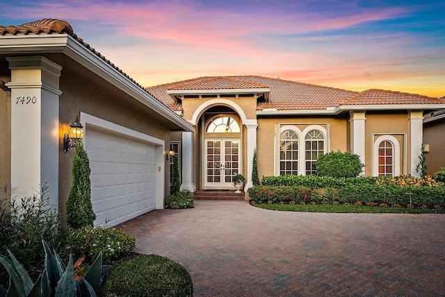 mediterranean / spanish house featuring a garage