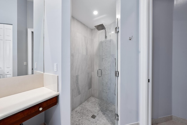 bathroom with tile patterned flooring, vanity, and an enclosed shower