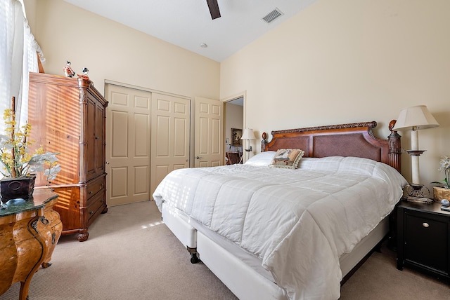 bedroom with light carpet, a closet, and ceiling fan