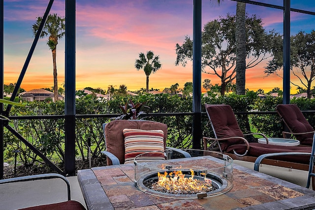 patio terrace at dusk featuring an outdoor fire pit