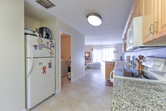kitchen featuring white appliances, light tile patterned floors, light countertops, a sink, and visible vents