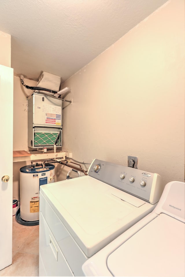 laundry area featuring light tile patterned flooring, independent washer and dryer, and laundry area