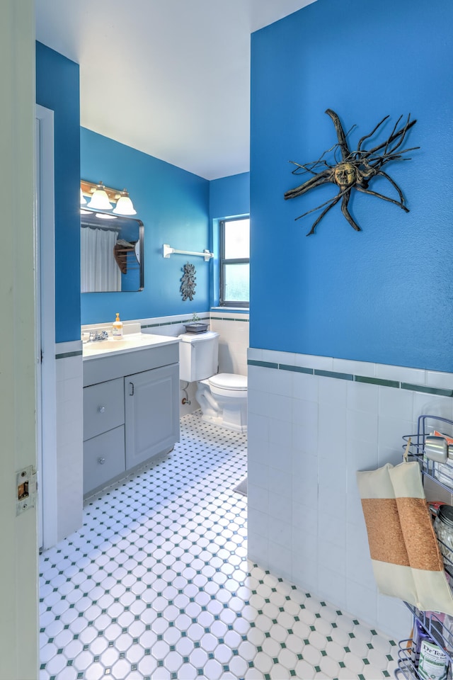 bathroom featuring tile patterned floors, vanity, and toilet