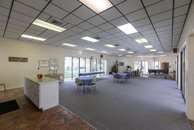 interior space featuring visible vents, a healthy amount of sunlight, carpet floors, and a paneled ceiling
