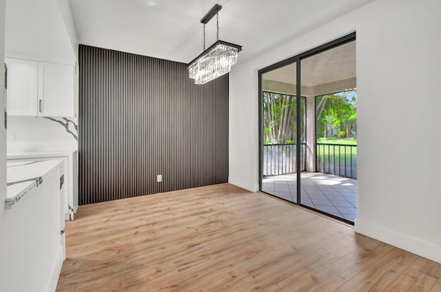 unfurnished dining area featuring light wood-type flooring