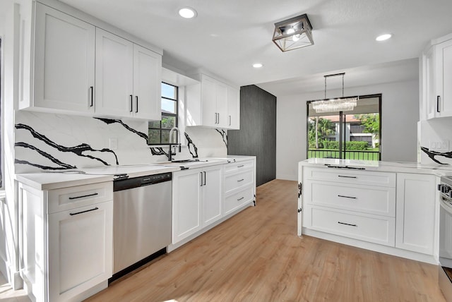 kitchen featuring a wealth of natural light, white cabinetry, light hardwood / wood-style flooring, and dishwasher