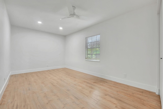 empty room with ceiling fan and light hardwood / wood-style flooring