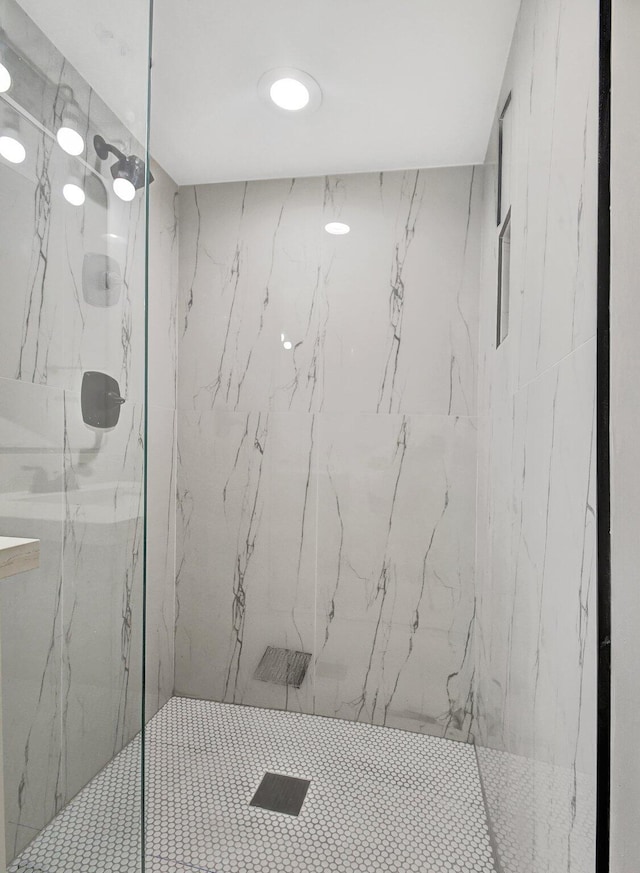 bathroom featuring a shower with shower door