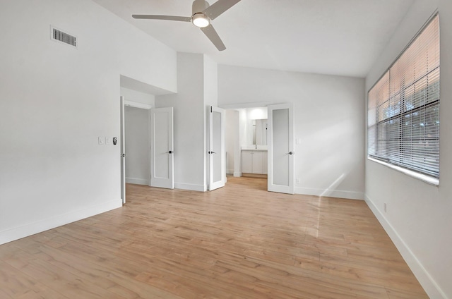 unfurnished room with high vaulted ceiling, ceiling fan, and light hardwood / wood-style flooring