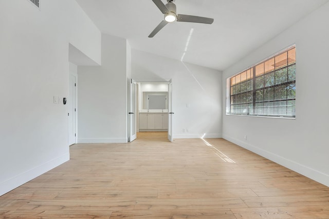 empty room featuring light wood-type flooring, ceiling fan, and vaulted ceiling