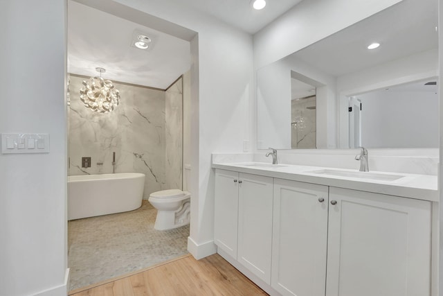 full bathroom with independent shower and bath, wood-type flooring, vanity, a notable chandelier, and toilet