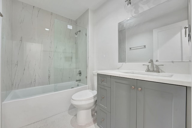 full bathroom featuring toilet, vanity, tiled shower / bath, and tile patterned flooring