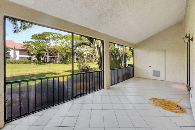 unfurnished sunroom with a wealth of natural light and lofted ceiling