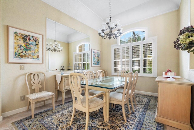 dining room with a textured ceiling and an inviting chandelier