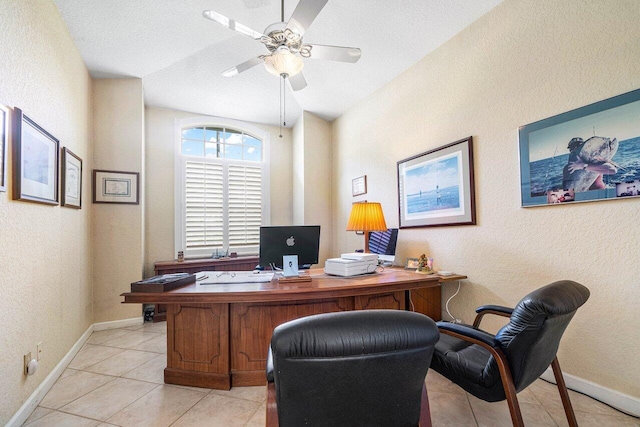 tiled office space featuring ceiling fan and a textured ceiling