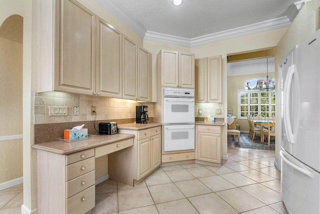 kitchen with a chandelier, a textured ceiling, white appliances, decorative light fixtures, and ornamental molding