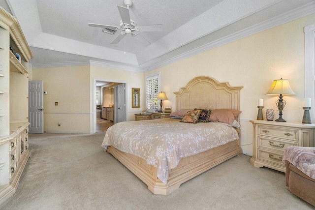 bedroom featuring a tray ceiling, light carpet, and ceiling fan