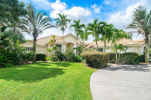 mediterranean / spanish-style home with a front yard