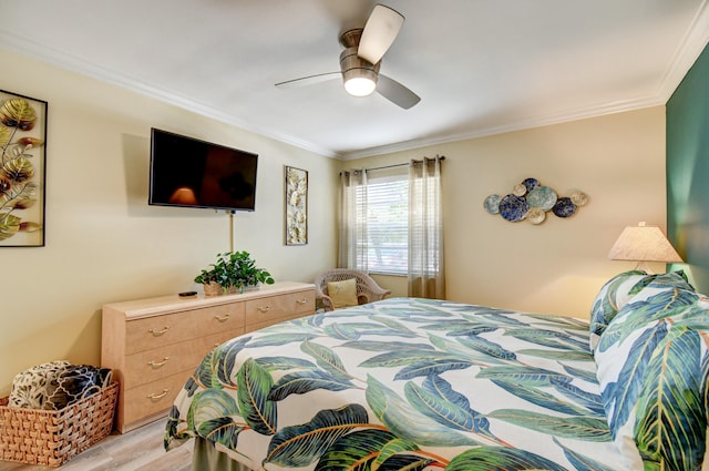 bedroom with ornamental molding, ceiling fan, and light hardwood / wood-style flooring