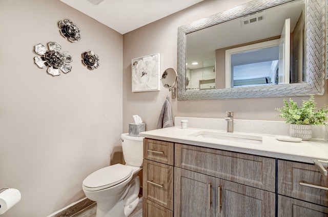 bathroom with vanity and toilet