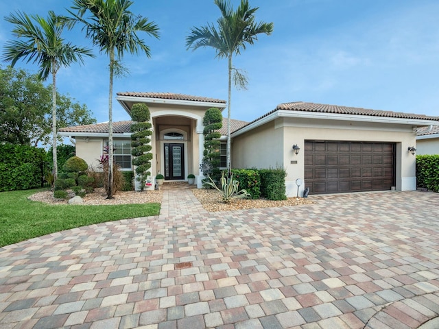 mediterranean / spanish home with a garage